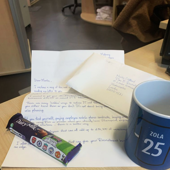 A handwritten letter sent with a mug and a chocolate bar